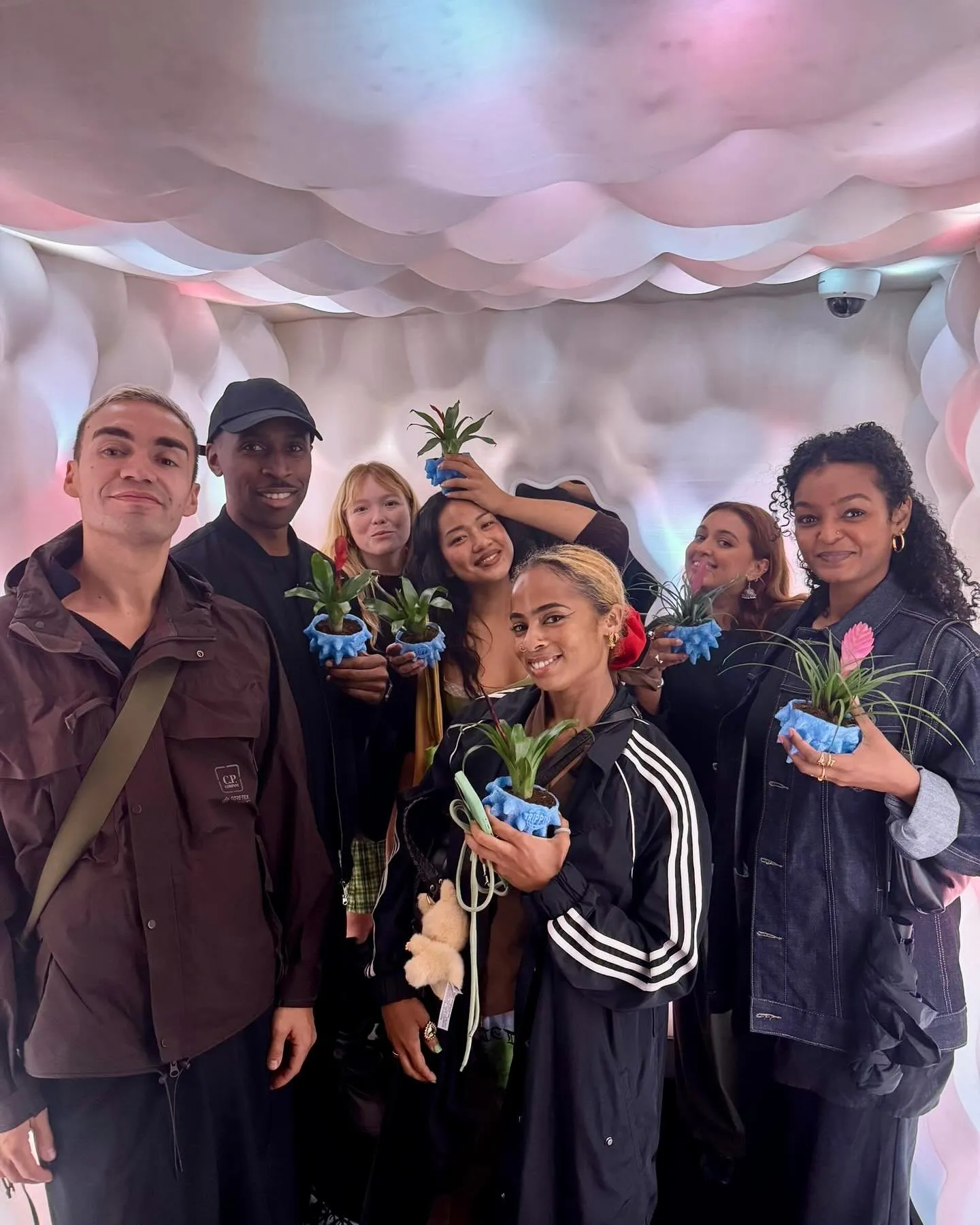 The Trippin team holding their coral plant pots
